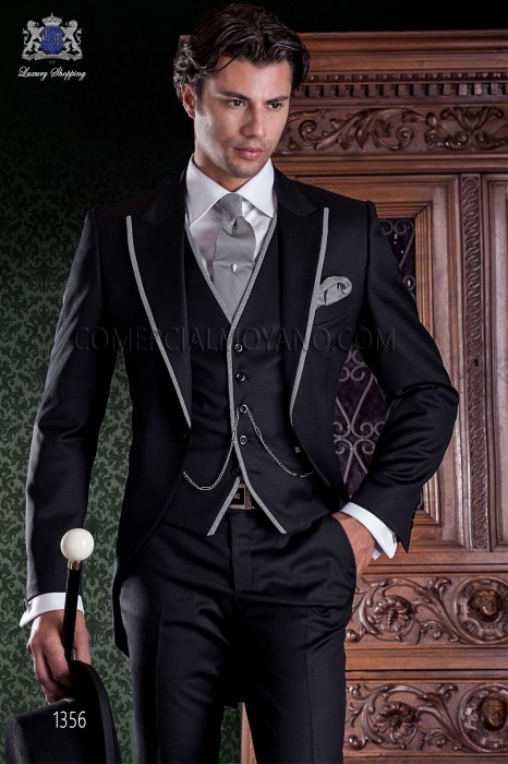 Chaqué de sastrería italiana de elegante corte “Slim”, una apertura. Tejido lana negro con vivos en contraste.
